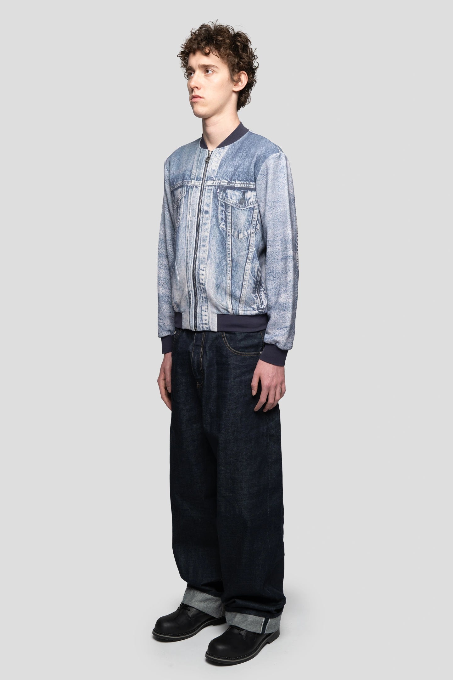 Side view of model wearing a jacket with a fake denim print on it Trampe l'oeil faded denim motif
