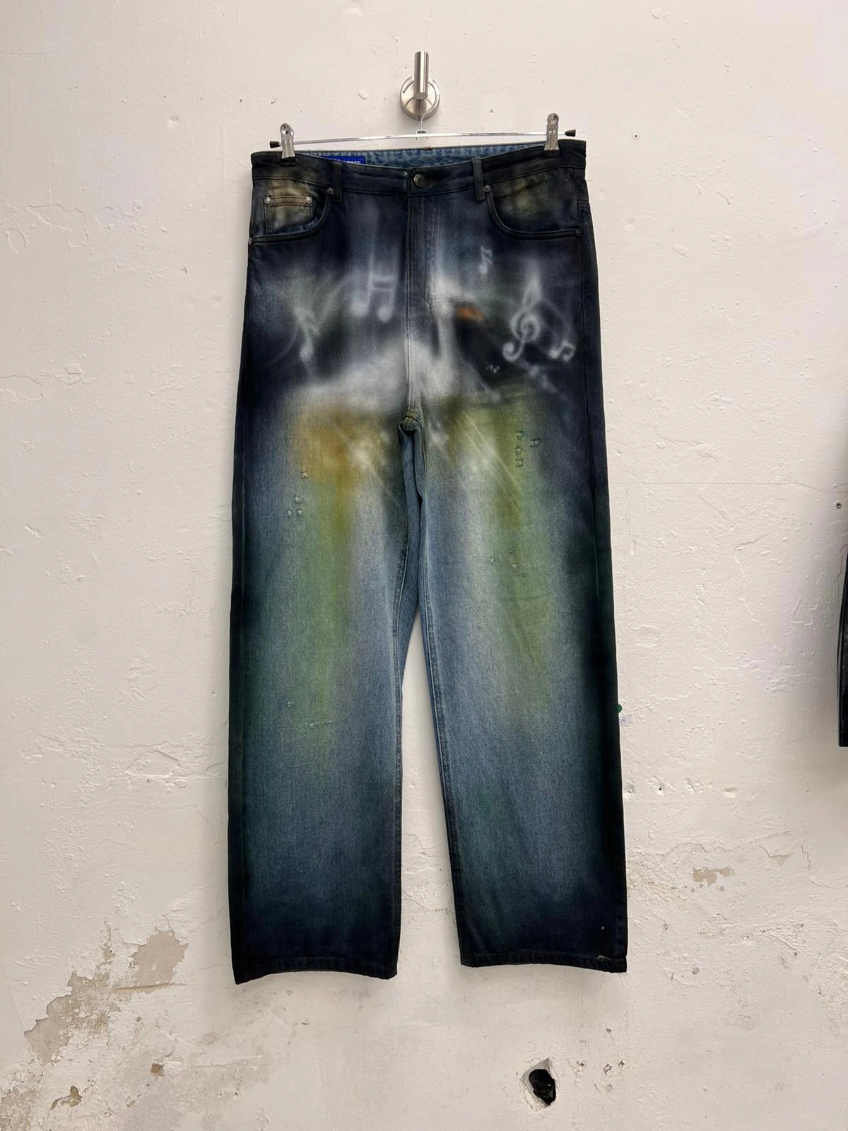 Kevin_Mejia_Grass_Stained_Denim_Pants painted with airbrush swan and notes motif