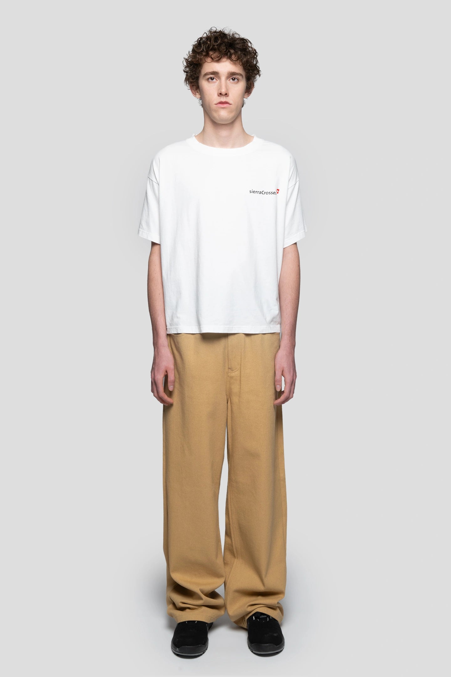 Model wearing a white t-shirt with beige working pants