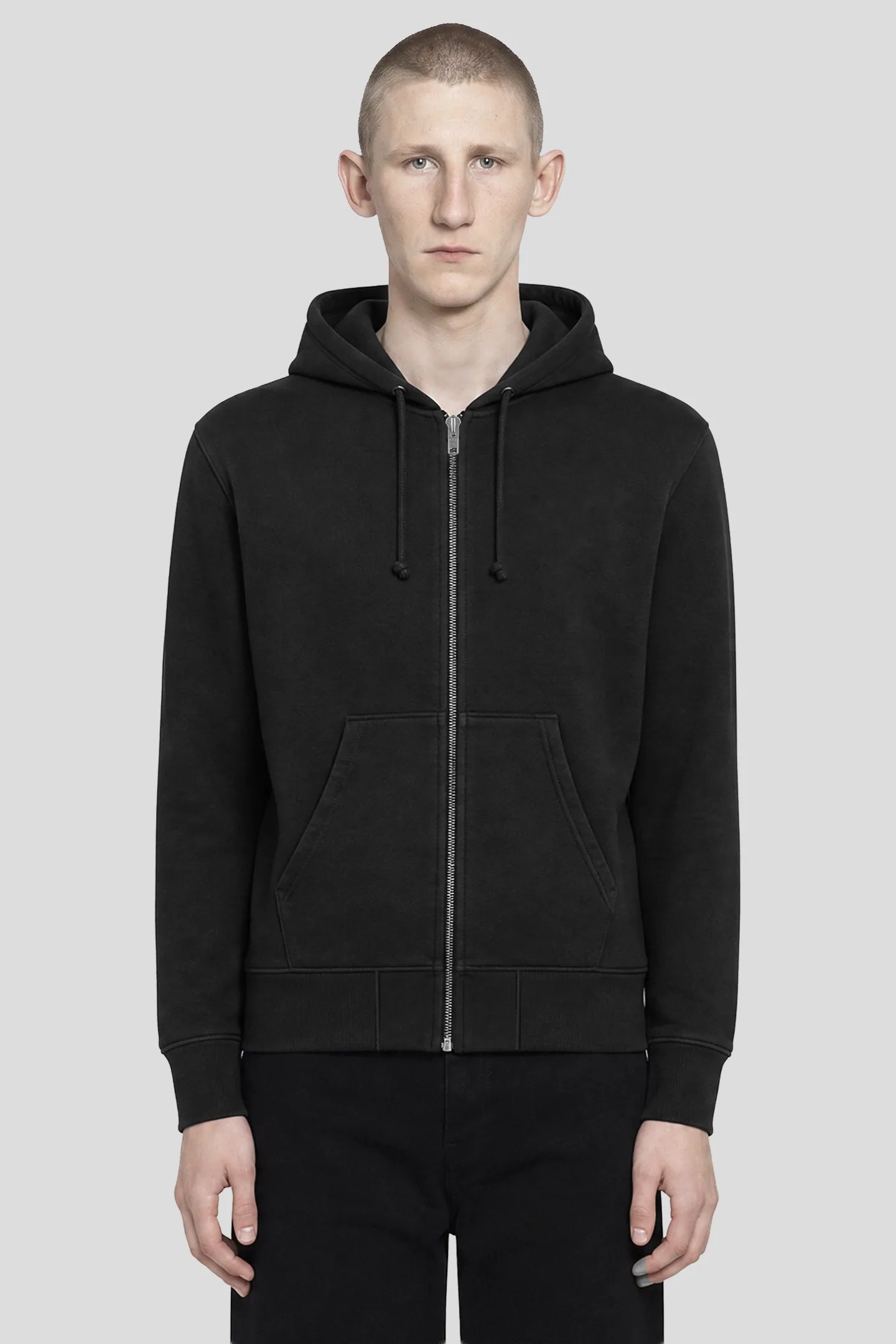 Model wearing the 93SC Signature Black Zip Hoodie, plain black reverse weave cotton hoodie, front view 93 SIERRA/CROSSES