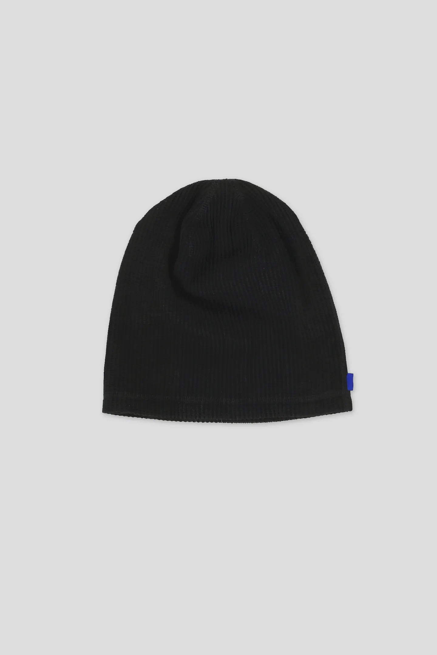Model wearing the Black Waffle Beanie with blue woven side tab by 93 SIERRA/CROSSES