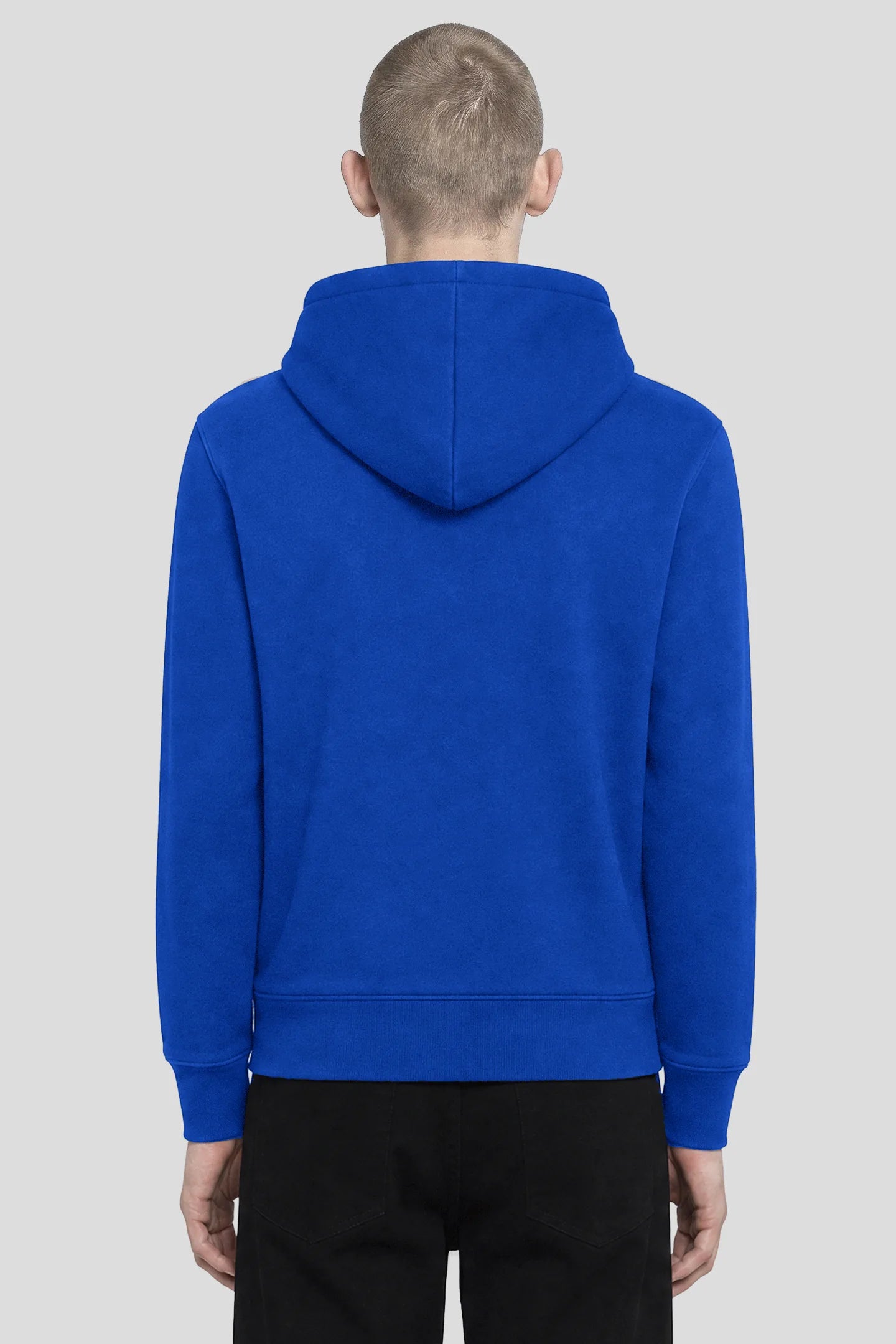 Back view of model wearing a plain blue zip hoodie with ribbed cuffs and hem by 93 SIERRA/CROSSES