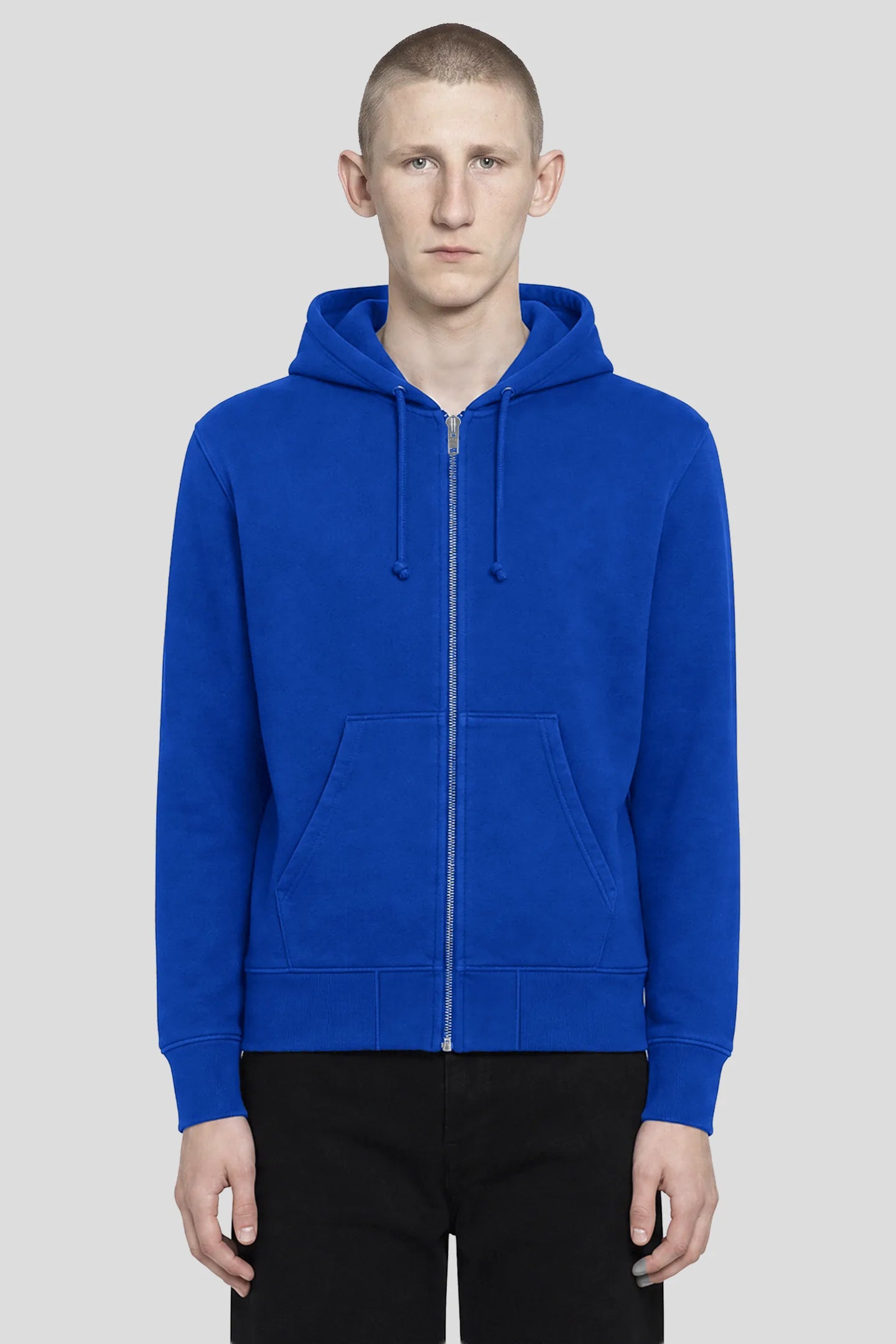 Model wearing the 93SC Signature Blue Zip Hoodie, plain blue reverse weave cotton hoodie, front view 93 SIERRA/CROSSES