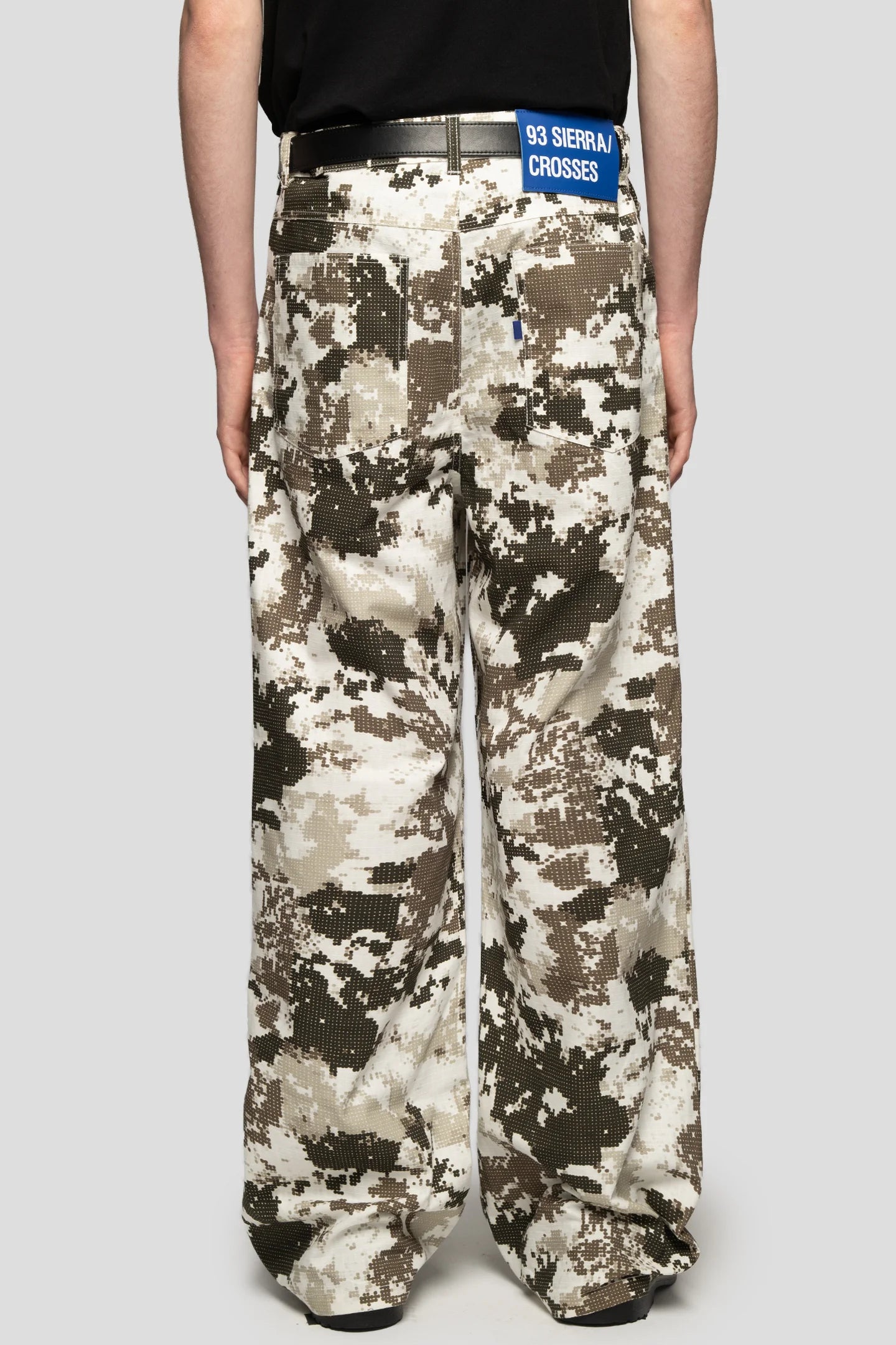Model wearing black and white digital camo trousers wide fit