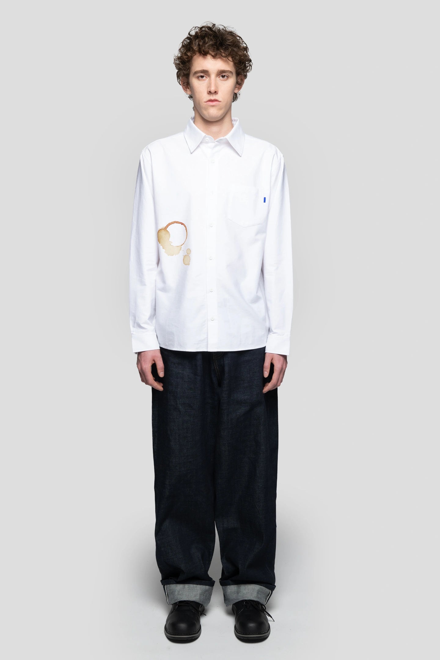front view model wearing white shirt with coffee stain effect by 93 sierra crosses