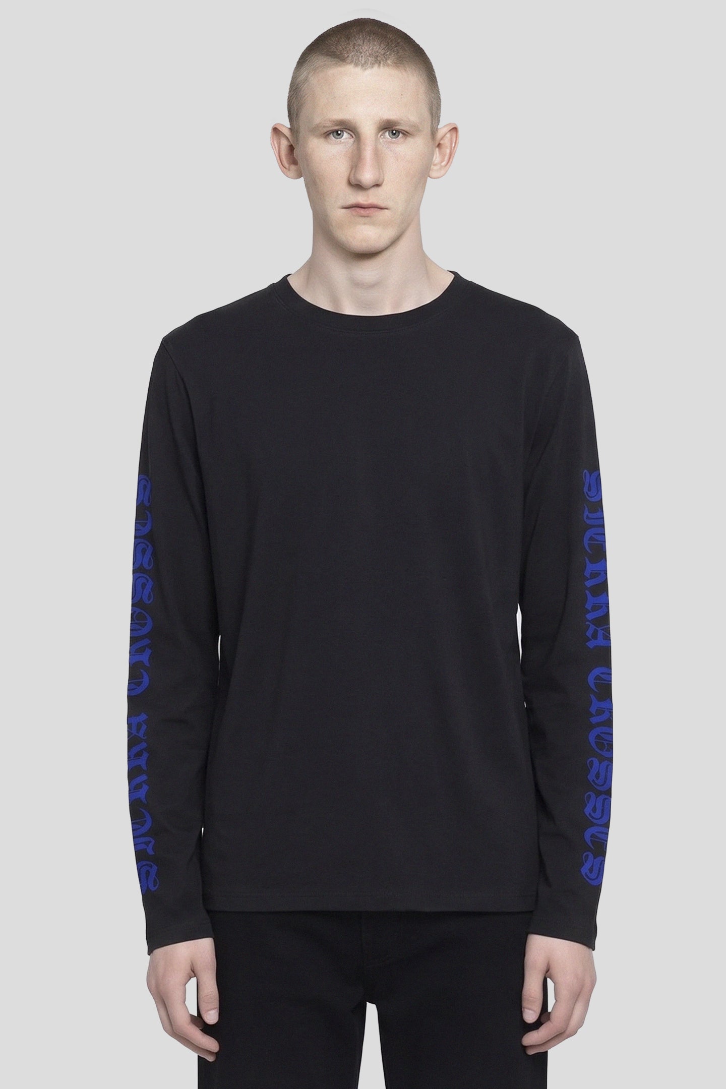 Model wearing the Crosshair LS T-Shirt, black long sleeve tee with blue gothic sleeve prints, front view 93 SIERRA/CROSSES
