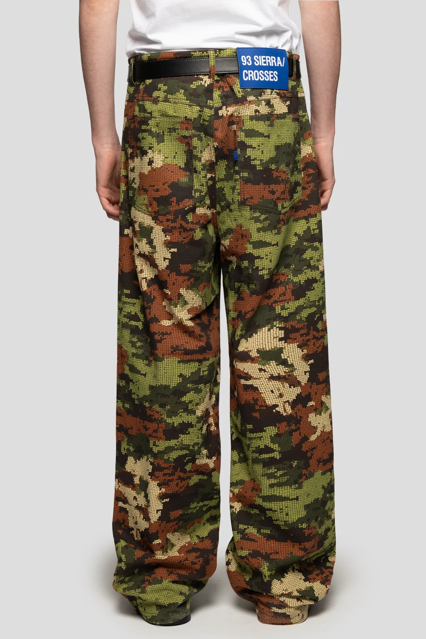 Back view of model wearing digital camo pant the pant falls in a relaxed way made by 93 sierra crosses