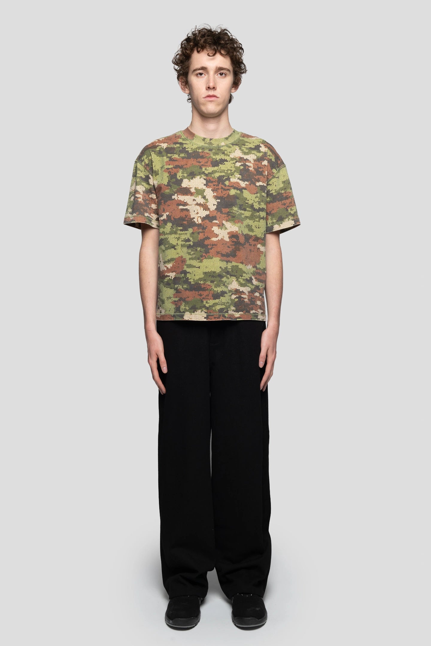 front view of model wearing digital militar camo t-shirt of last collection of 93 sierra crosses