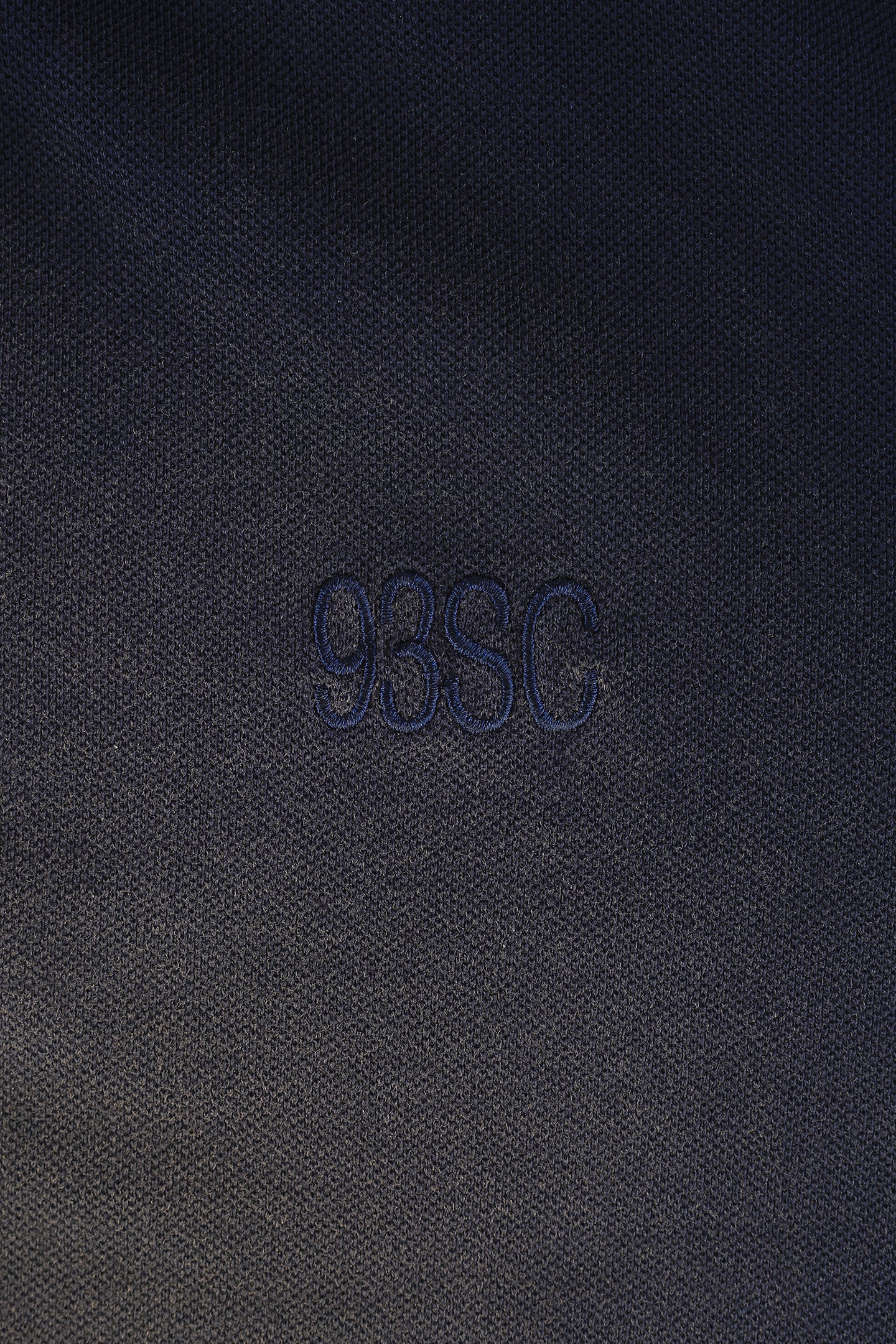 embroided navy blue logo on same color polo shirt 93 sierra crosses detailed view
