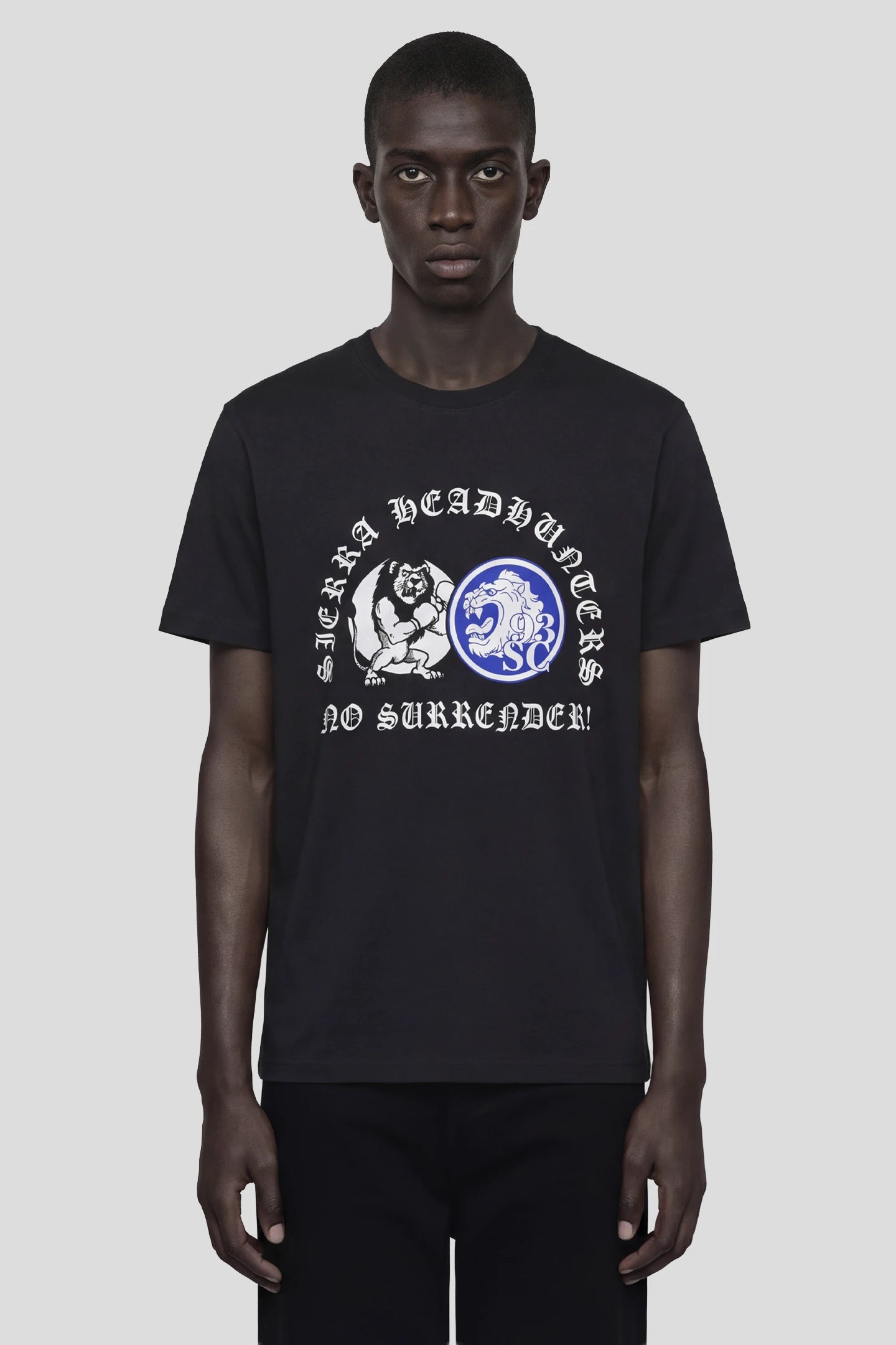 Model wearing the Headhunters T-Shirt, black tee with Sierra Headhunters No Surrender! print, front view 93 SIERRA/CROSSES
