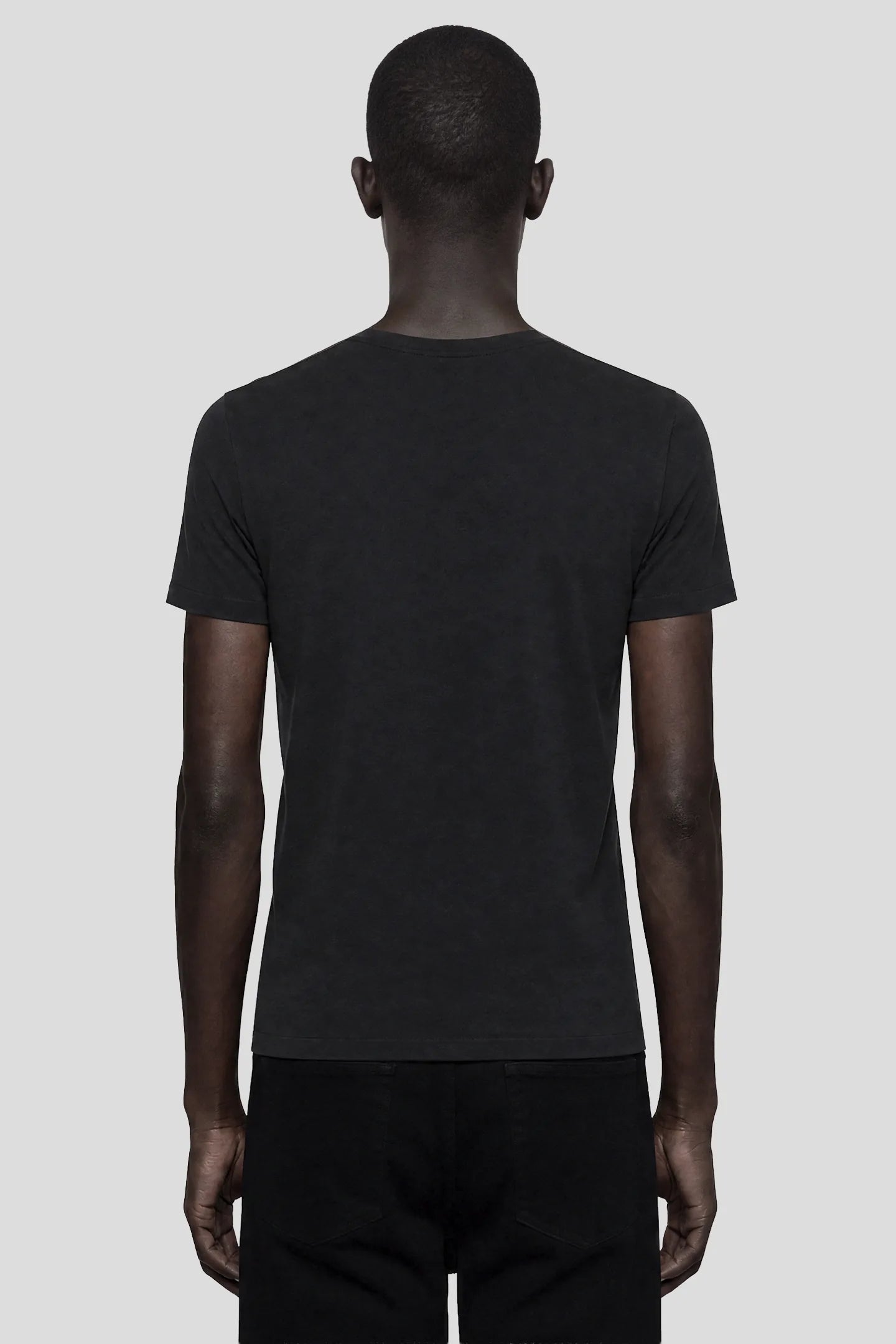 Model wearing the 93SC Signature Black T-Shirt, a 100% cotton crew neck tee, front view by 93 SIERRA/CROSSES