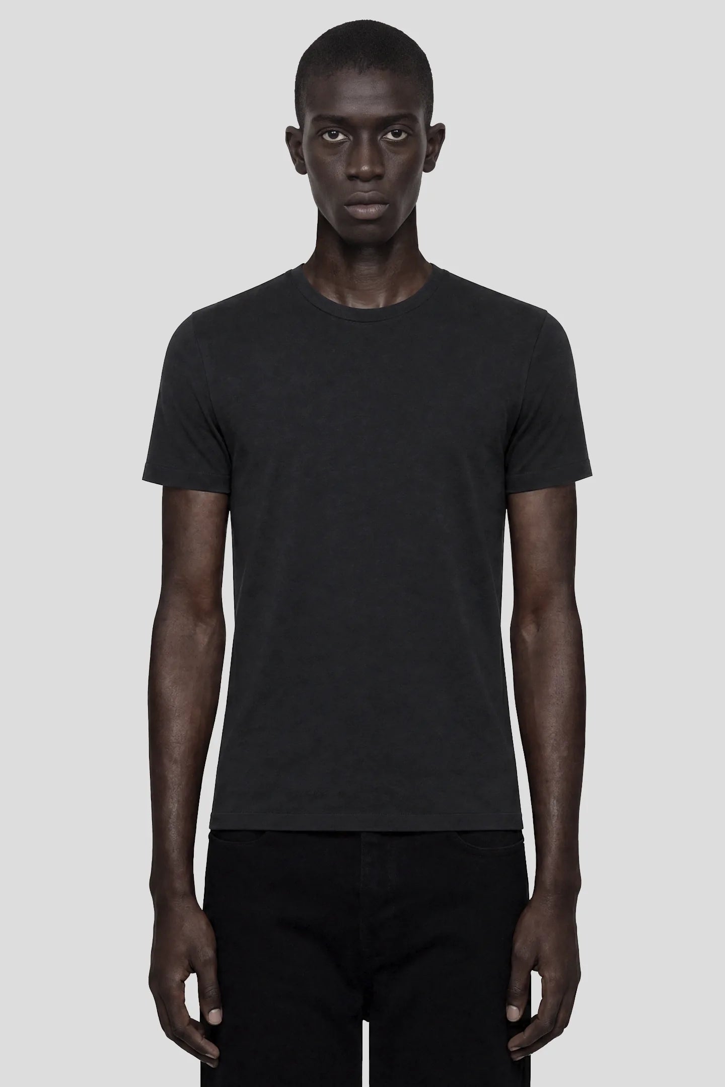 Model wearing the 93SC Signature Black T-Shirt, a 100% cotton crew neck tee, front view by 93 SIERRA/CROSSES