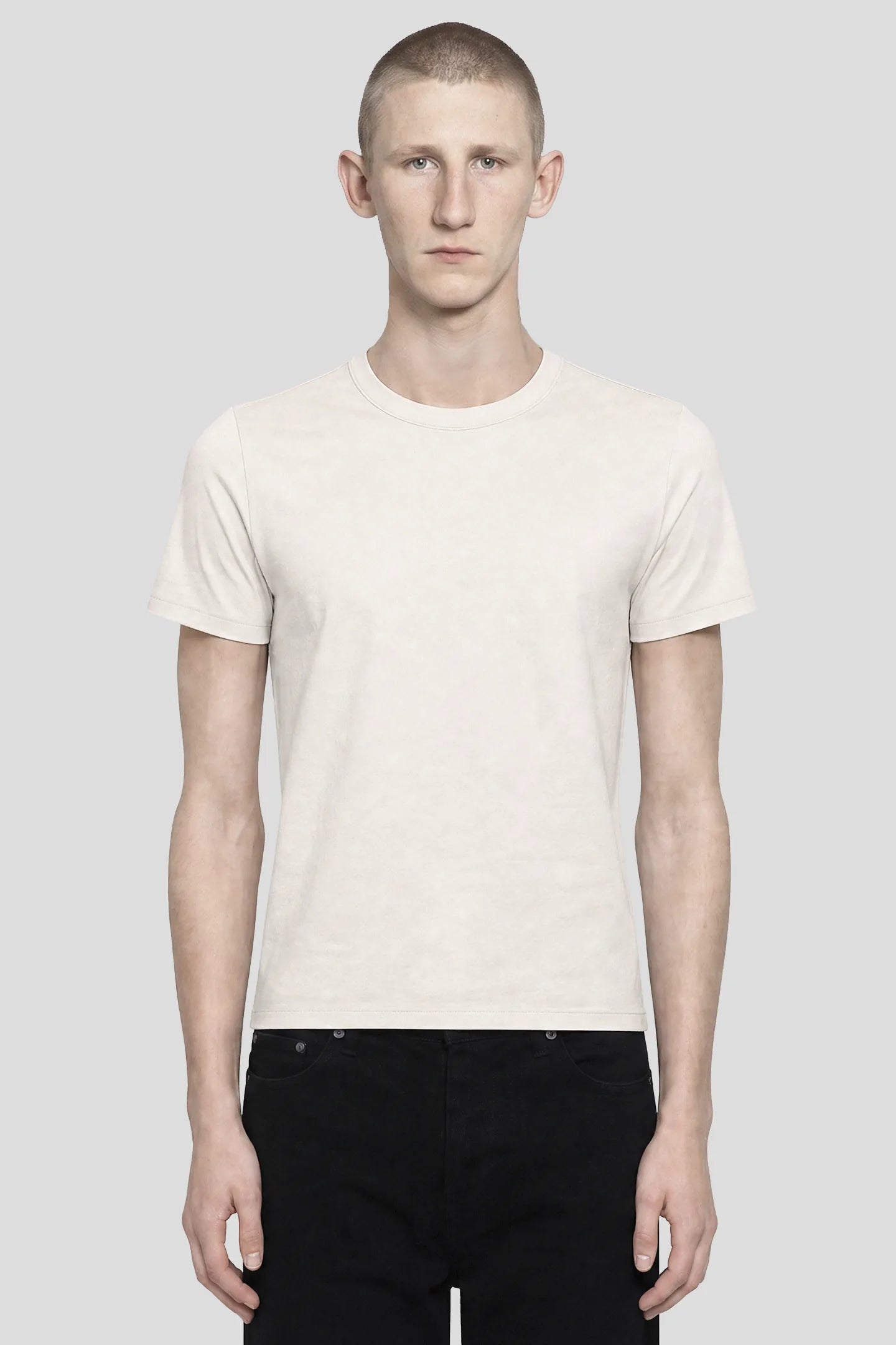 Model wearing the 93SC Signature White T-Shirt, a 100% cotton crew neck tee, front view by 93 SIERRA/CROSSES