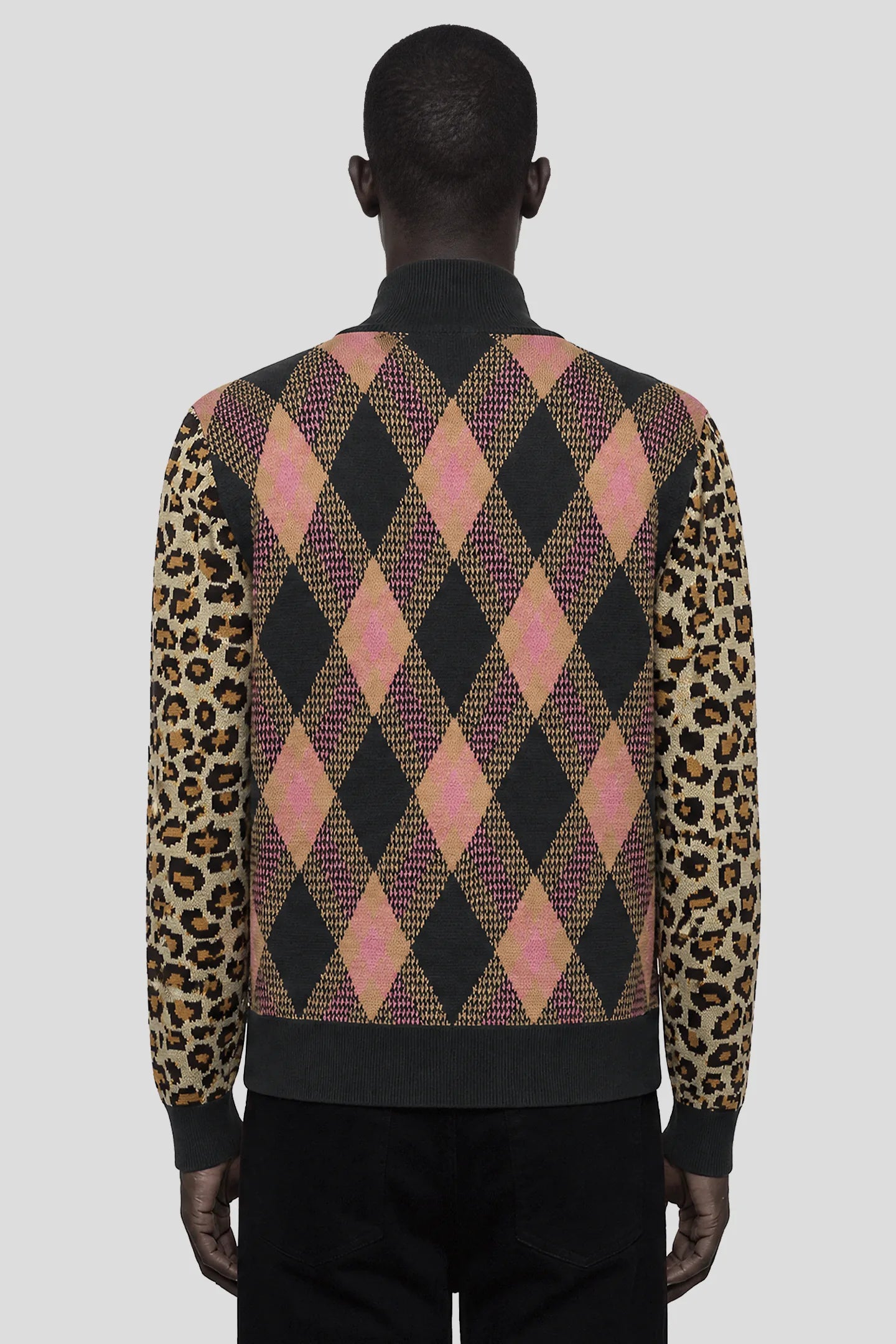 Model wearing the Tartan Cheetah Knit Sweater, full-zip argyle knit with leopard sleeves 93 SIERRA/CROSSES