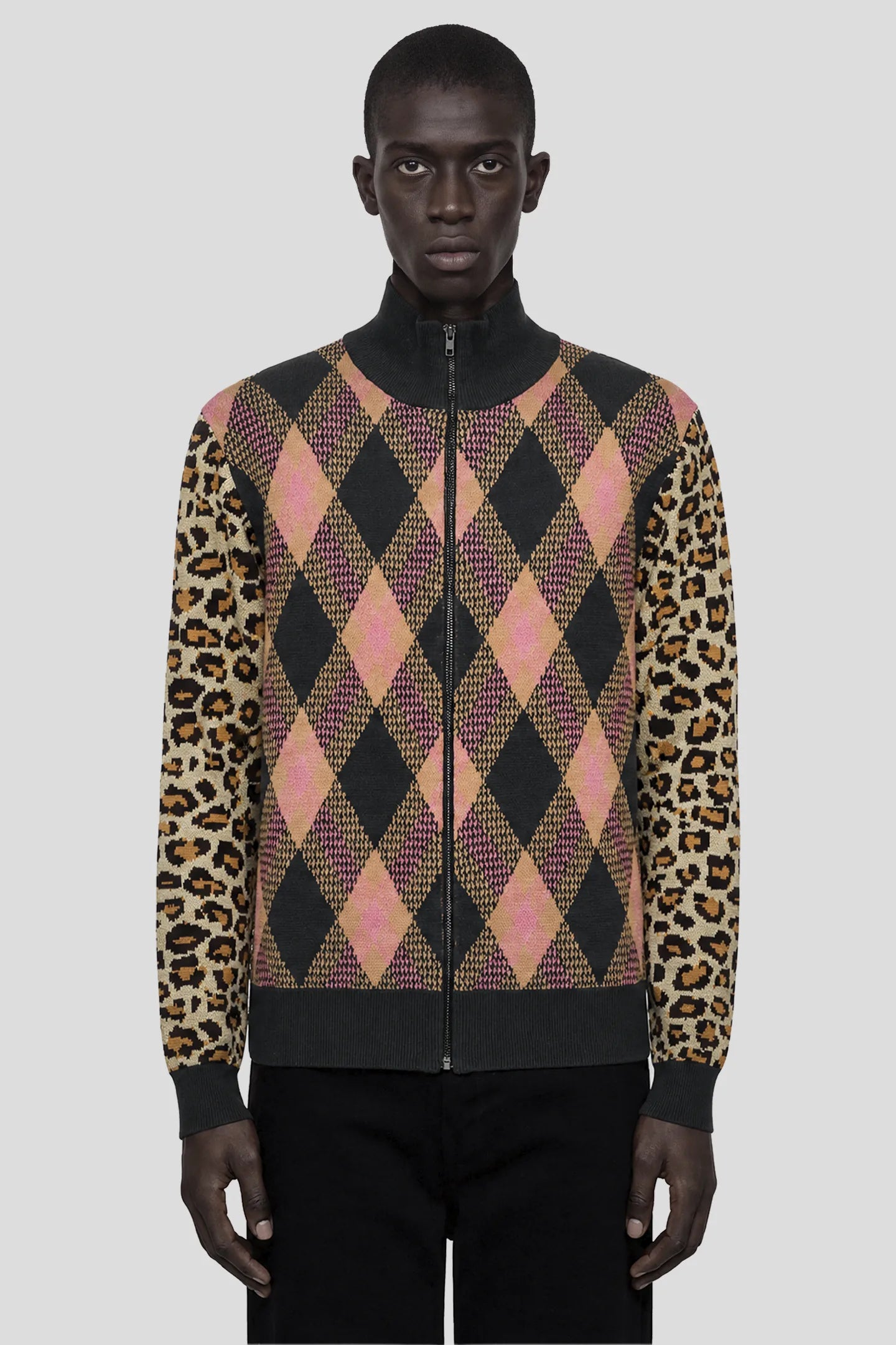Model wearing the Tartan Cheetah Knit Sweater, full-zip argyle knit with leopard sleeves 93 SIERRA/CROSSES