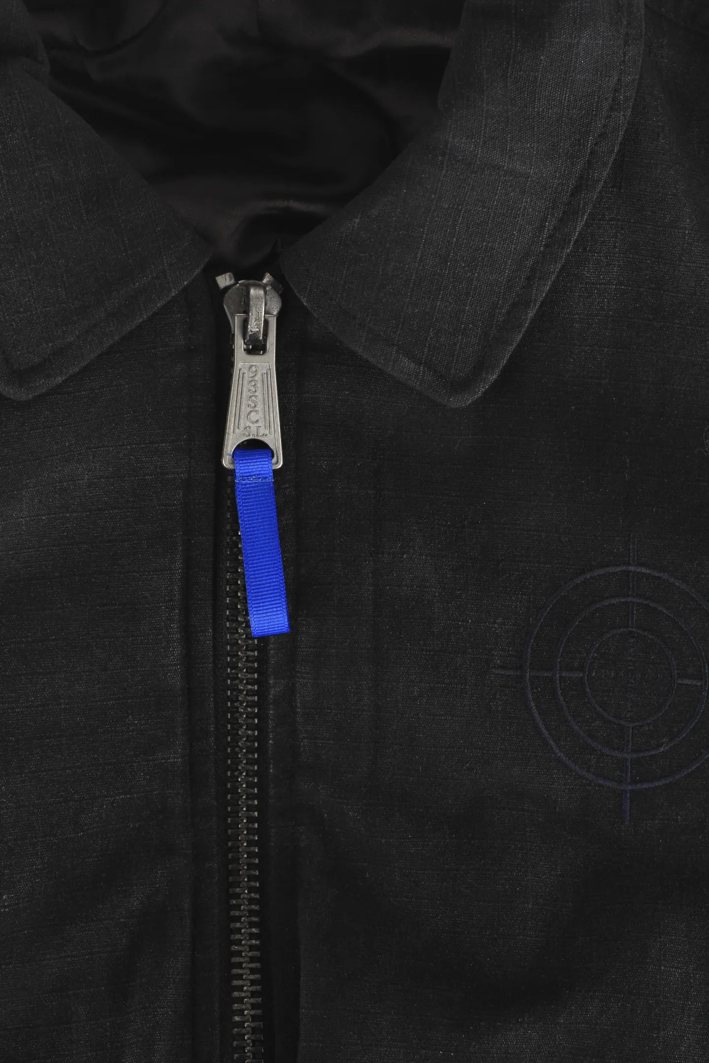 Crosshair chest embroidery, point collar and blue zip puller on the black waxed bomber jacket 93 SIERRA/CROSSES
