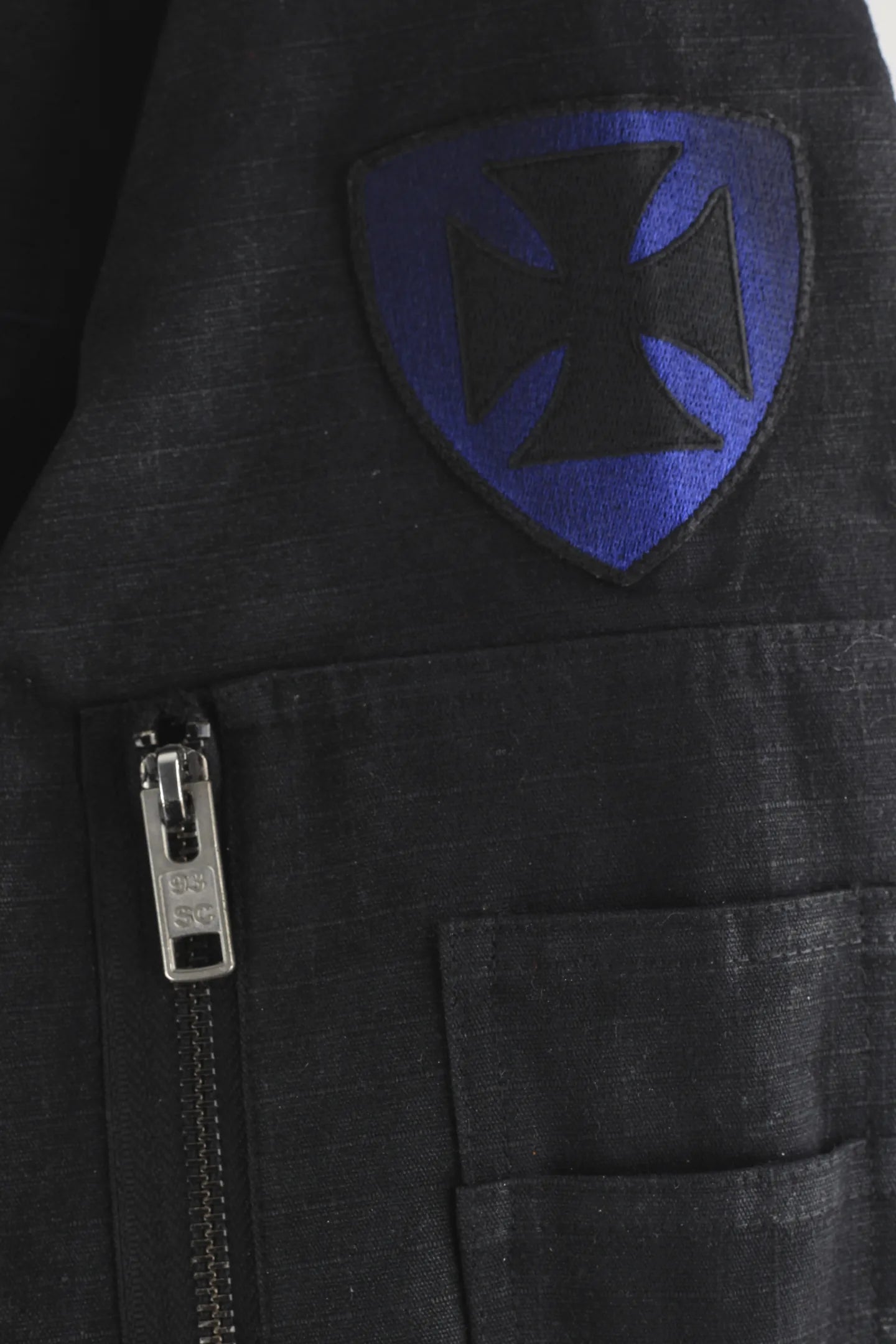 Iron cross shield patch and 93SC branded zip on the sleeve utility pocket of the waxed bomber jacket 93 SIERRA/CROSSES